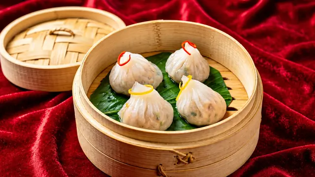 Chicken and chive dumplings tied with pepper ribbons